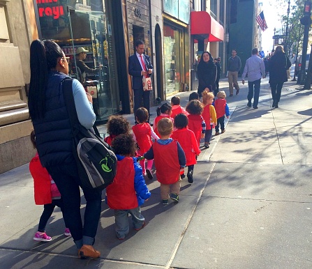 New York USA-16 November 2015: group of children under the supervision of adult educators on walk around the  New York city.
