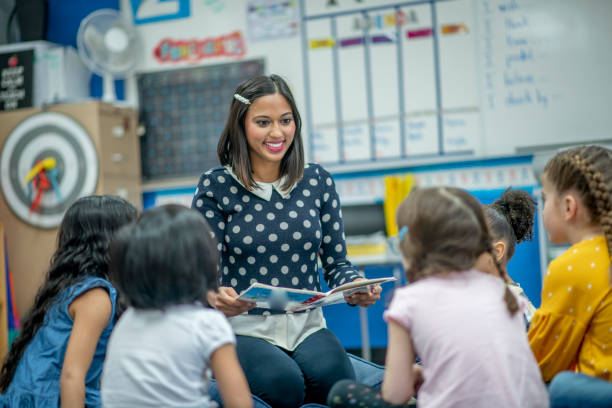 istock Indian kindergarten teacher reads to class 1293937558