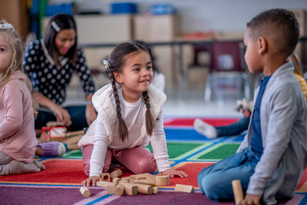 istock Multi ethnic children interacting together in preschool 1293937572