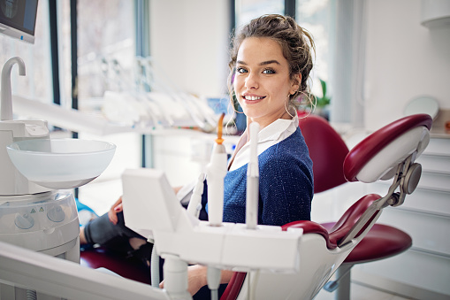 Portrait of young woman in a dentist office
