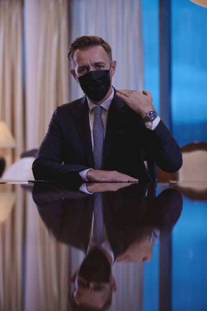 istock business man wearing protective face mask at luxury office 1293941017