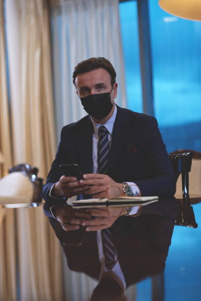 istock business man wearing protective face mask at office 1293941703