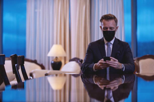 istock business man using smart phone at luxury office wearing face mask 1293944541