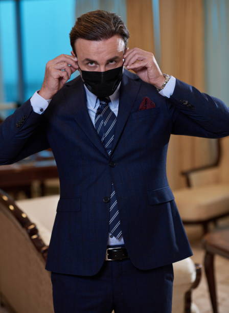 istock business man wearing protective face mask at office 1293945386