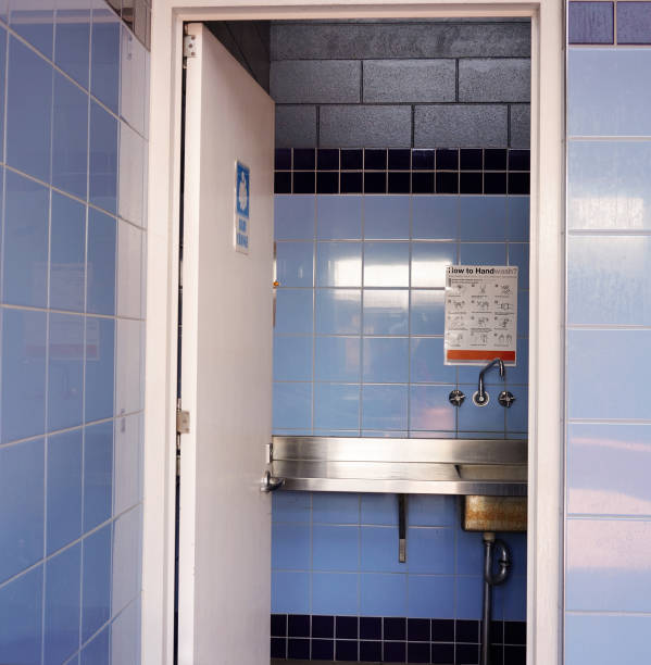 Townsville, Queensland, Australia - December 2020: Inside a blue tiled male public toilet at a rest stop