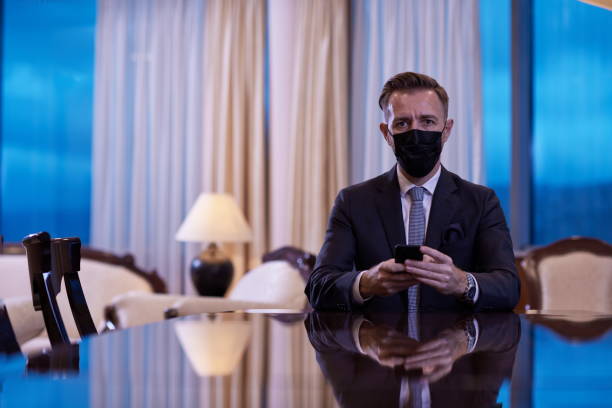 istock business man using smart phone at luxury office wearing face mask 1293948726
