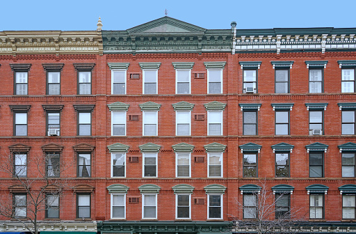 old fashioned apartment building facade with ornate roofline decorations