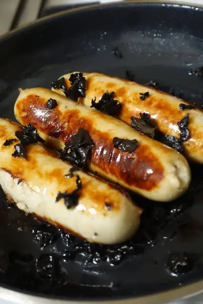 Photo of White pudding during cooking with black mushrooms 