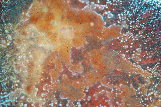 istock Red rust is caused by the condition that iron loses electrons when it reacts with water 1293962776