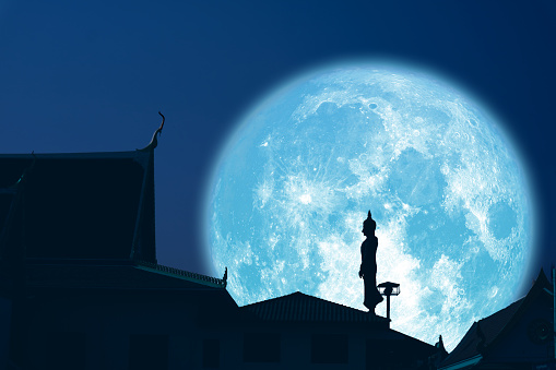 Sunday Buddha and super blue moon on night sky in the Asanha bucha daysky, Elements of this image furnished by NASA, https://solarsystem.nasa.gov/resources/843/rare-full-moon-on-christmas-day/?category=moons_earths-moon