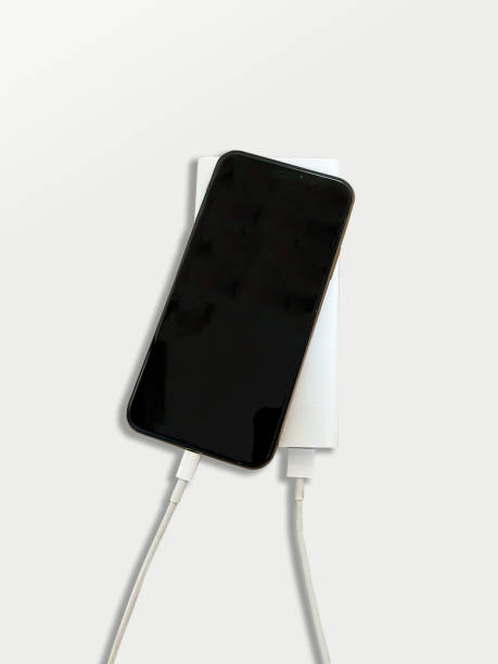 istock phone charging with a portable battery on a white-gray background 1293963510
