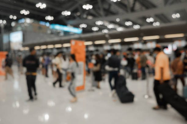 istock Blur Background of airport Check-In counters with many passengers and light bokeh 1293967843