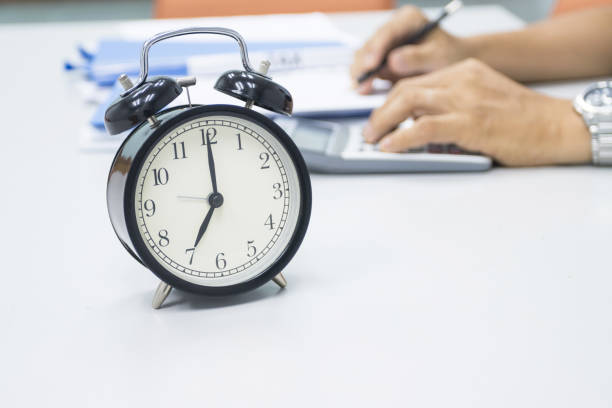 istock 7 AM Clock on work desk in the office Time of businessman working concepts selective clock 1293968700