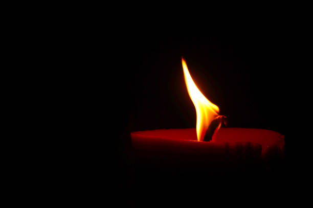 istock One candle flame at night closeup 1293971166