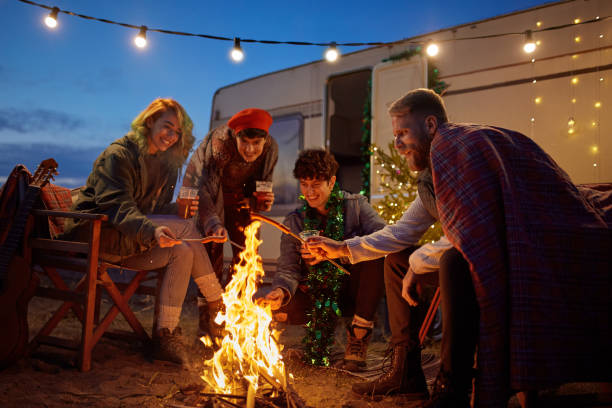 istock Friends Roasting Sausages Around Campfire 1293975808