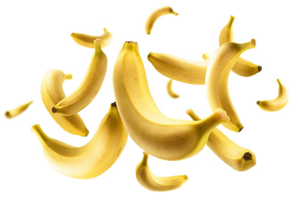 Yellow bananas levitate on a white background.