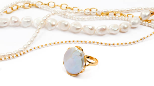 istock Luxury elegant baroque pearl ring and necklaces on white background 1293983505