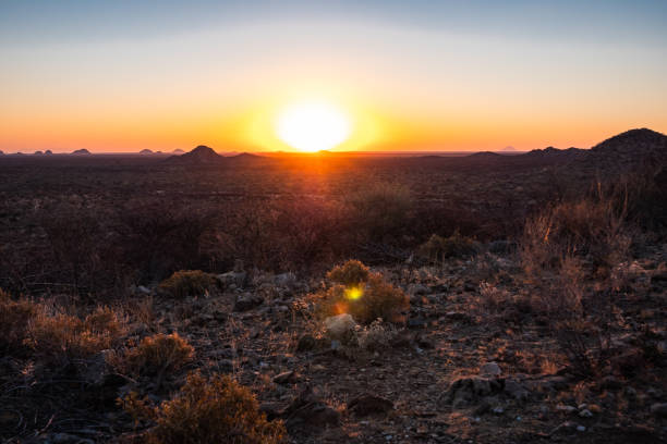 Sunset in the Savanna in Omaruru in the Erongo Region of Namibia Sunset in the Savanna in Omaruru in the Erongo Region on the Central Plateau of Namibia, Africa, a Scenic Sundown in the African Wilderness bushveld photos stock pictures, royalty-free photos & images