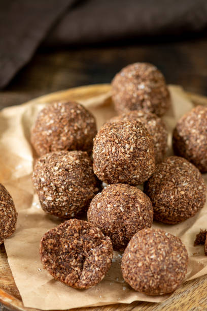 istock Chocolate coconuts. Chocolate balls with coconut. Chocolate candies or cookies with coconut, cinnamon and powdered sugar 1293986363