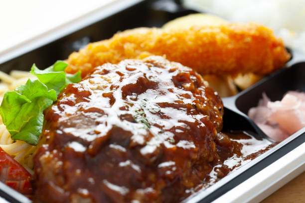 istock Close-up of a lunch box containing hamburger steak. 1293990324