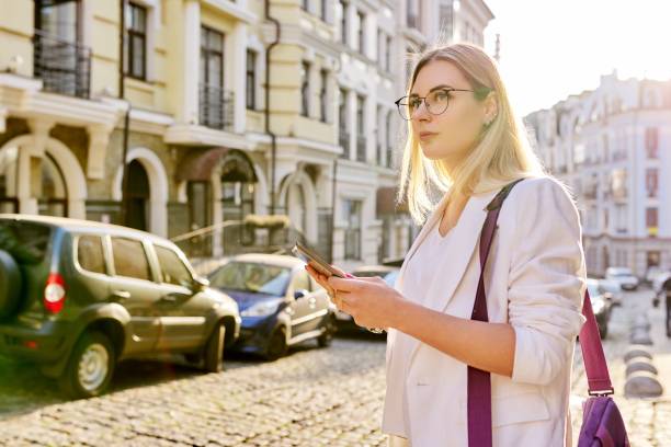 istock Young business woman in city using digital tablet 1293996759