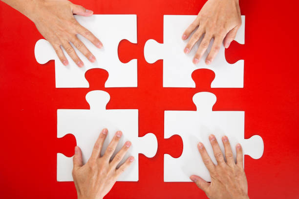 istock business people hand assembling jigsaw puzzle and represent team support-business concept 1294002233