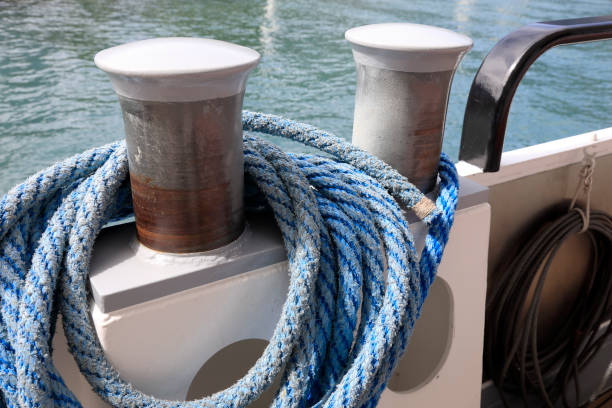 Stainless steel cleat with white rope, background with copy space, full frame horizontal composition