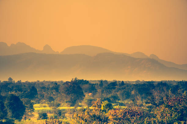 landscape view hills or mountain layer photo and forest on sunset silhouette background, beautiful sunset scenic nature, golden light sunny on sky background on many hill, abstract beautiful nature.