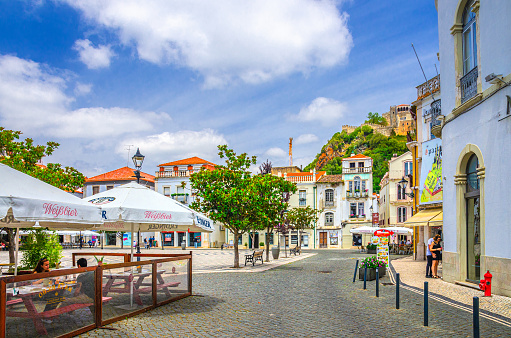 Leiria, Portugal, June 22, 2017: Praca Rodrigues Lobo square with typical traditional buildings, houses and street restaurant in Leiria city historical centre