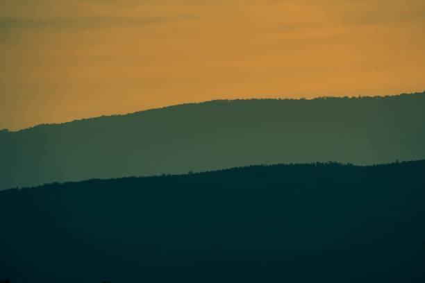 Photo of landscape view hills and forest on sunset silhouette background