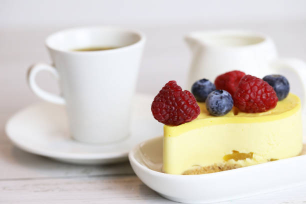 istock light cake with raspberries and blueberries and a cup of coffee 1294012766