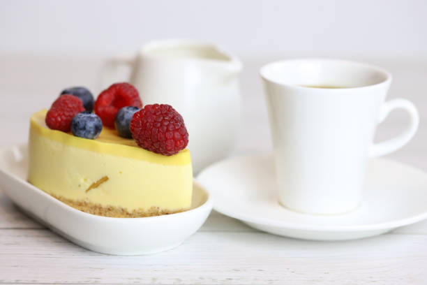 istock light cake with raspberries and blueberries and a cup of coffee 1294012773