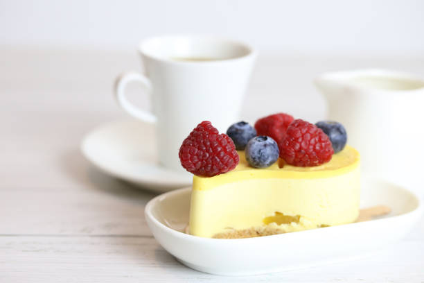 istock light cake with raspberries and blueberries and a cup of coffee 1294012779