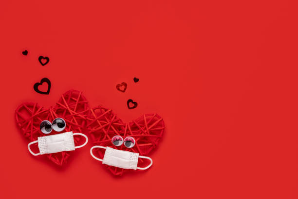 istock Red hearts couple in love with protective mask Valentine… 1294013785
