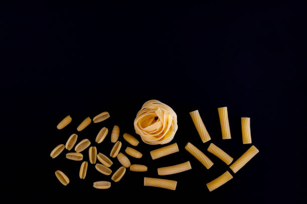 istock Italian pasta closeup on black background. Macaroni.  Spaghetti. Selective Focus. 1294014725