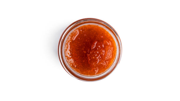 istock Orange jam in a glass isolated on a white background 1294015862