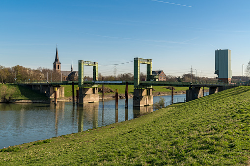 Duisburg, North Rhine-Westphalia, Germany - March 27, 2017: Lift bridge with the Johanneskirche (church) of Walsum in the background