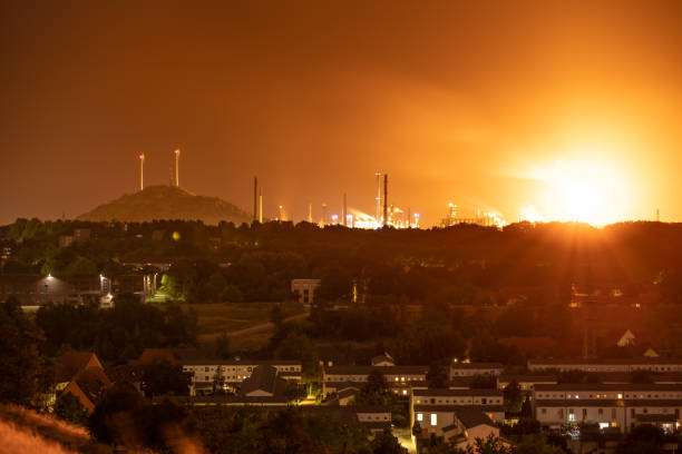 Gelsenkirchen, North Rhine-Westfalia, Germany - July 25, 2018: Night view over the Ruhr Area from the Rungenberghalde, with a steel factory in the background