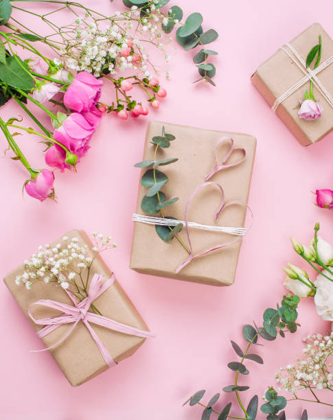 istock Craft paper wrapping gift boxes on pink background with blank space 1294020007