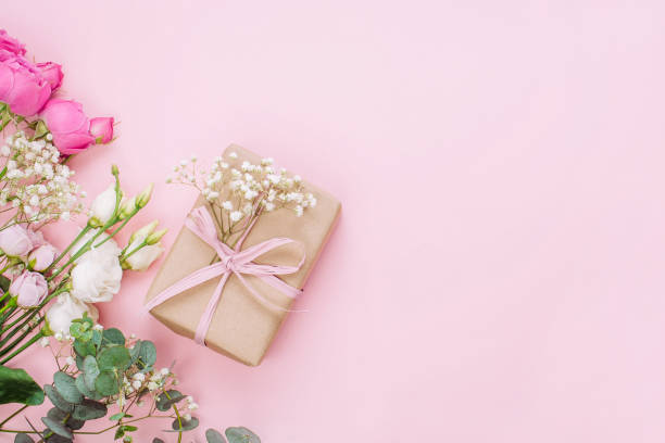 istock Craft paper wrapping gift boxes on pink background with blank space 1294020008