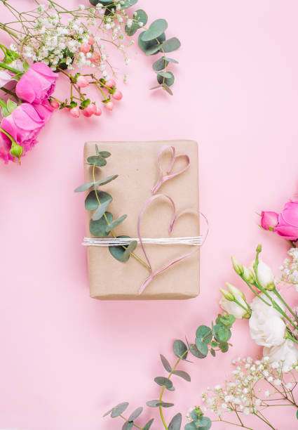 istock Craft paper wrapping gift boxes on pink background with blank space 1294020020