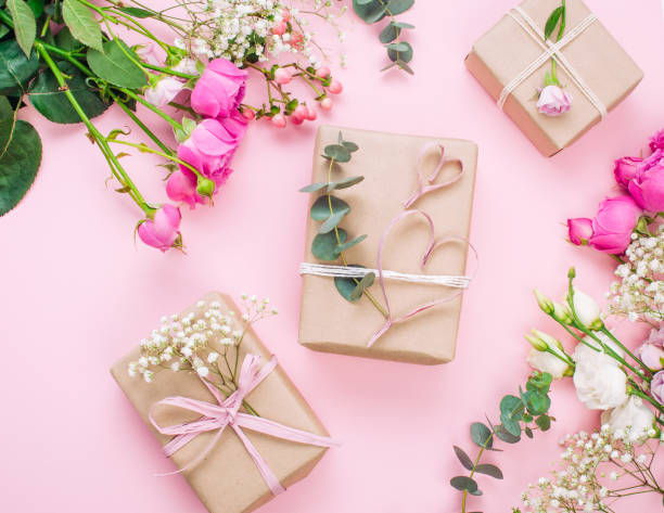 istock Craft paper wrapping gift boxes on pink background with blank space 1294020022