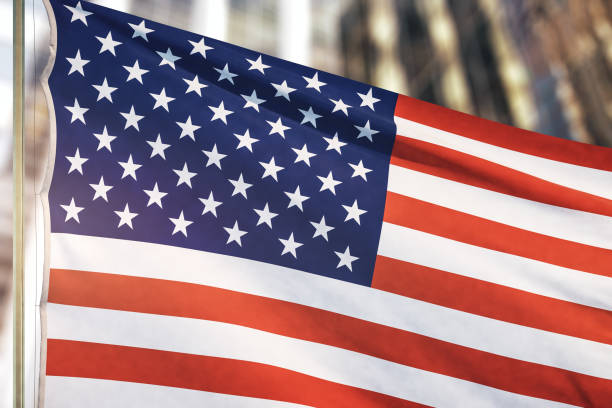istock USA flag on blurry skyscraper background, close up 1294021929