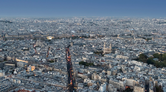 Aerial view of Paris at dusk with the city illuminated