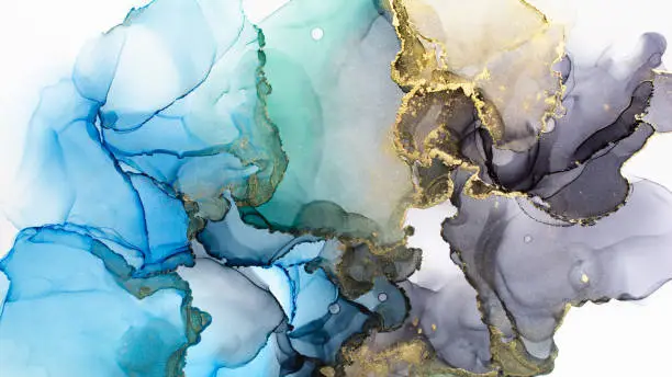 Photo of Closeup of blue, grey and shiny golden alcohol ink abstract texture