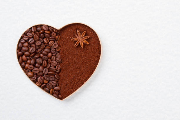 istock Coffee beans and powder in a heart-shaped form. 1294028031