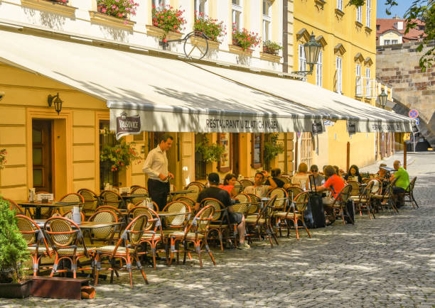 Prague, Czech Republic - August 2018: People sitting on outside tables in a restaurant in Prague.