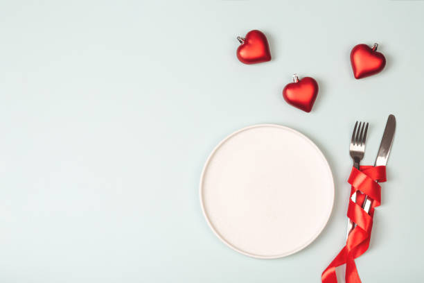 istock Empty white plate and cutlery. Valentine's Day theme. 1294030040