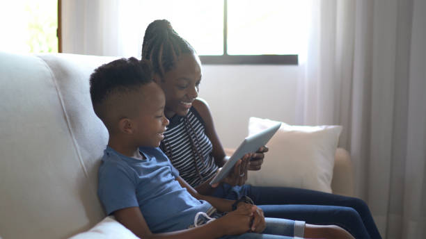 istock Siblings watching movie on digital tablet at home 1294032145
