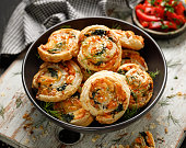 Puff Pastry Pinwheels stuffed with salmon, cheese and spinach in a ceramic bowl